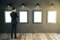 Businessman looking at picture frames