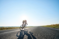 Bicyclist on open road riding for mental health