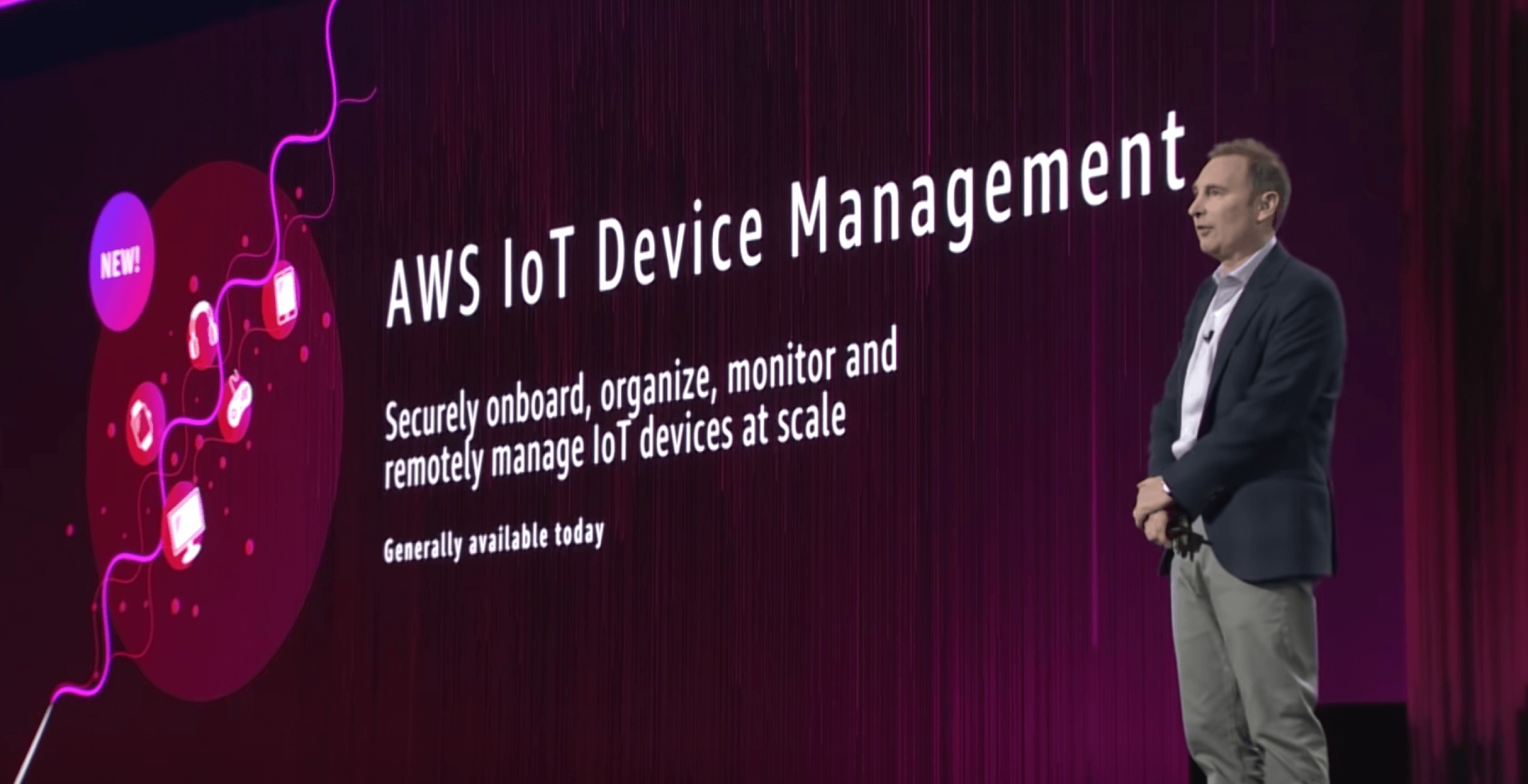 AWS ReInvent conference speaker on stage talking about AWS IoT Device Management
