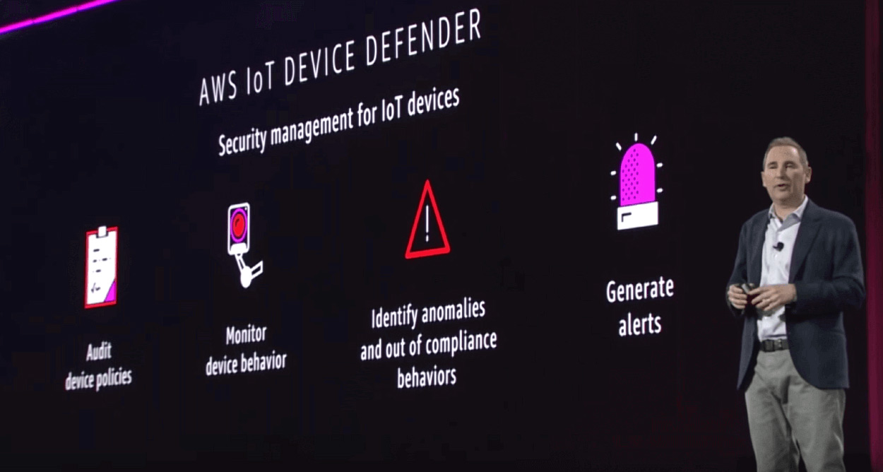 AWS ReInvent conference speaker on stage talking about AWS security management for IoT device