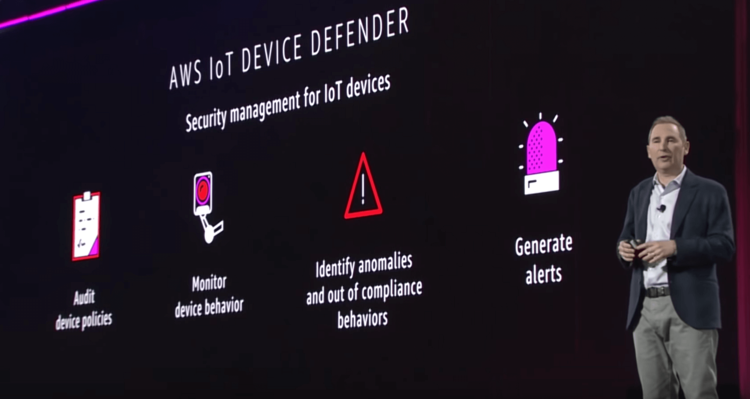 AWS ReInvent conference speaker on stage talking about AWS security management for IoT device